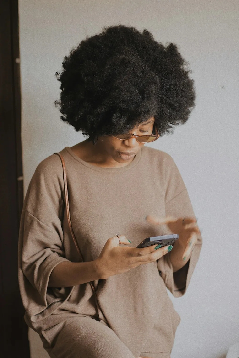 A woman checking her transfer details on her phone